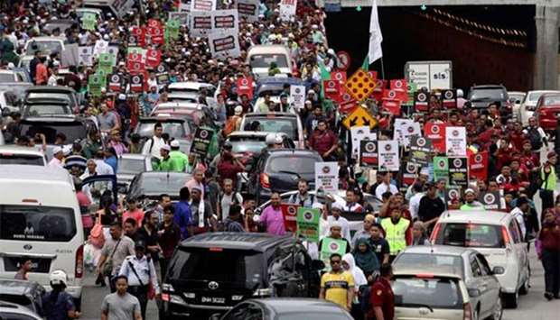 Pro-Palestine protesters march towards the US embassy in Kuala Lumpur on Friday.