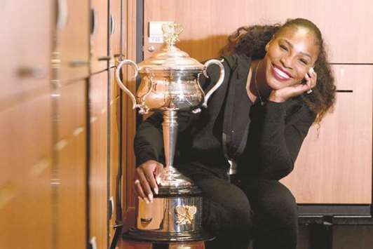 In this January 28, 2017, picture, Serena Williams poses with the championship trophy in the locker room after she won the Australian Open in Melbourne. (AFP)