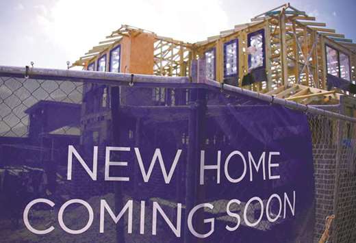 A house under construction can be seen behind an advertising banner at a housing development located in the western Sydney suburb of Oran Park in Australia. Chinese buyers account for nearly a quarter of all new-built purchases in Sydney and about 15% in Melbourne, according to a Credit Suisse analysis.