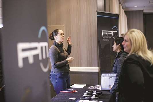 A recruiter from RPM (left), speaks with job seekers at a National Career Fairs event in Dearborn, Michigan. Nonfarm payrolls rose by 228,000 jobs last month amid broad gains in hiring as the distortions from the recent hurricanes faded, Labour Department data showed yesterday.