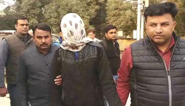 Police take the teenager suspected of killing his mother and sister for questioning, in Greater Noida yesterday.