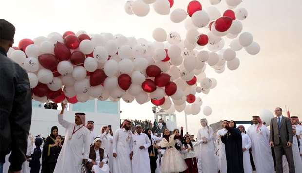 Balloons in Qatar's national colours and embossed with the famed Tamim Al Majd image are released at the launch of National Day celebrations at Darb al Saai. Picture: Thajudeen