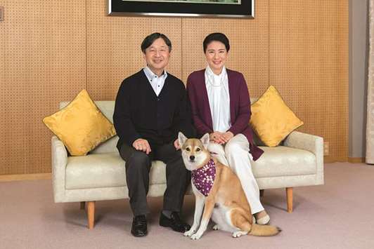 Japanu2019s Crown Princess Masako and her husband Crown Prince Naruhito pose for a photograph with their pet dog Yuri at Togu Palace in Tokyo, Japan.