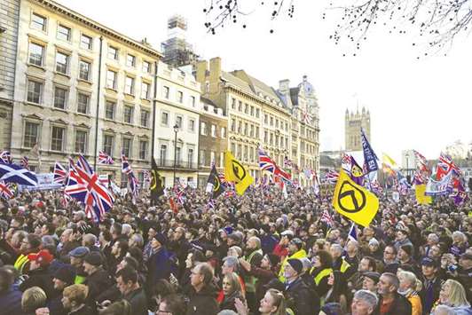 Protesters hold up placards and Union flags as they attend a pro-Brexit rally promoted by Ukip in central London yesterday.