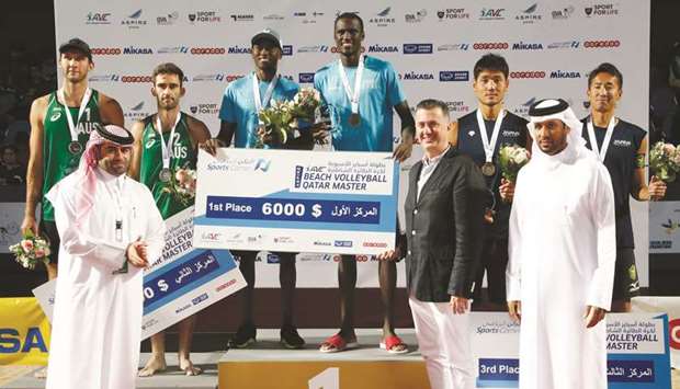 Qataru2019s Cherif Younousse and Ahmed Tijan pose on the podium with the winnersu2019 trophies and the cheque after winning the Asian Volleyball Confederation (AVC) Aspire Qatar Master at Aspire Park yesterday. PICTURES: Jayaram
