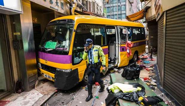 Police investigate after an empty schoolbus crashed in the North Point district of Hong Kong