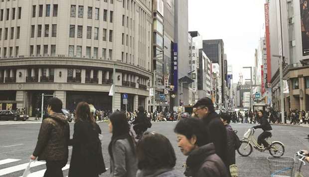 Pedestrians walk along a street in the Ginza shopping district in Tokyo. The Japanese economy contracted the most in over four years in the third quarter as companies slashed spending, threatening to chill the investment outlook in 2019 as the export-reliant nation grapples with slowing global growth and trade frictions.