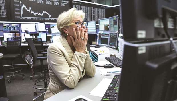 A trader monitors financial data inside the Frankfurt Stock Exchange. The DAX 30 closed down 1.5% to 10,622.07 points yesterday.