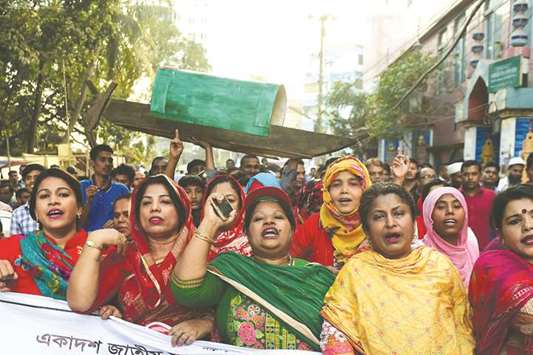 Awami League supporters march in the street as they take part in a general election campaign procession in Dhaka yesterday.