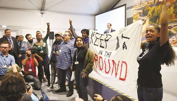 Environmental activists protest against fossil fuel during US panel at the COP24 UN Climate Change Conference 2018 in Katowice, Poland, yesterday.