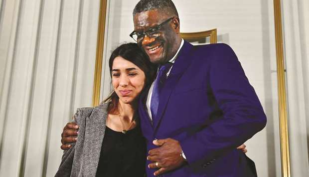 Mukwege and Murad hug at the end of a press conference in Oslo yesterday, on the eve of the Peace Prize ceremony.