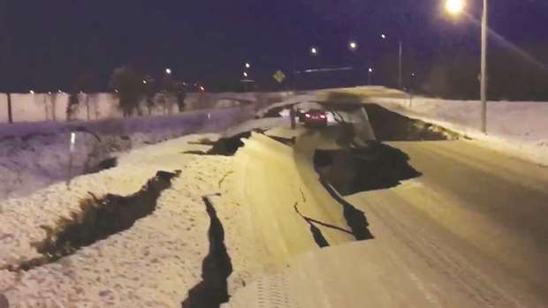 Cracks on Minnesota Drive near Anchorage are seen in this still image taken from a social media video.