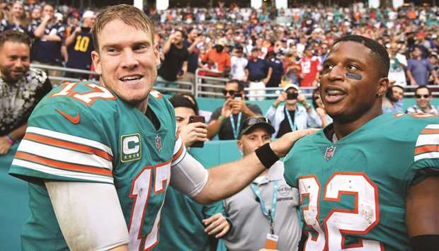 Ryan Tannehill (left) and Kenyan Drake of the Miami Dolphins celebrate their win over the New England Patriots at Hard Rock Stadium in Miami. (AFP)