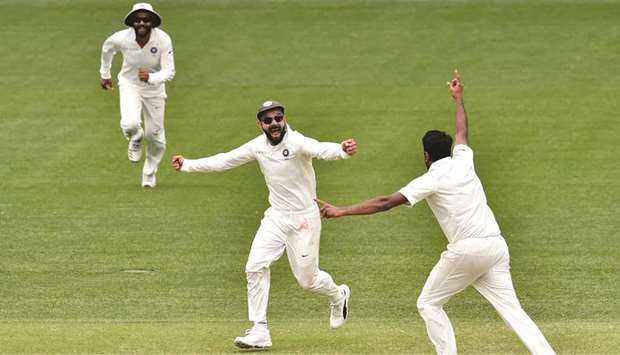 Captain Virat Kohli (centre) and Ravichandran Ashwin (right) celebrate Indiau2019s victory over Australia in the first Test in Adelaide yesterday. (AFP)