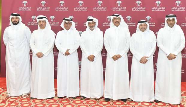 Qatar Football Association president HE Sheikh Hamad bin Khalifa bin Ahmed al-Thani (centre) poses with other officials after being re-elected for another four-year term at the General Assembly of the body yesterday.