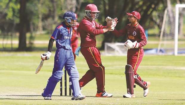 Qatar players celebrate taking a wicket during the match against Thailand in Bangkok yesterday.