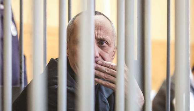 Popkov is seen inside the defendantsu2019 cage during the court hearing in Irkutsk.