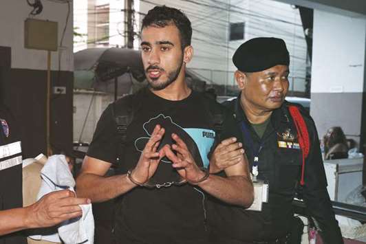 Hakeem Alaraibi, a former member of Bahrainu2019s national soccer team who holds a refugee status in Australia arrives at court after he was arrested last month on arrival at a Bangkok airport based on an Interpol notice issued at Bahrainu2019s request, in Bangkok, Thailand.