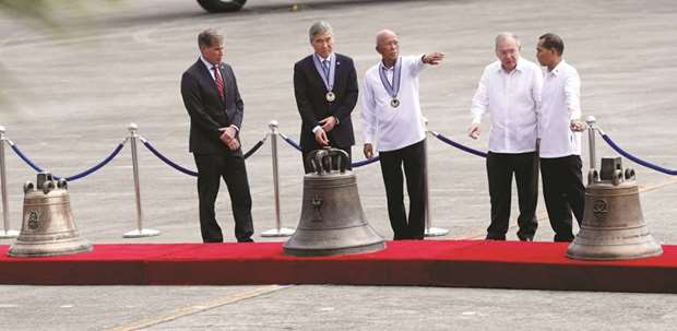 Defence Secretary Delfin Lorenzana and US ambassador to the Philippines Sung Kim lead a ceremony marking the return of the Balangiga bells, at Villamor Air Base in Pasay, Metro Manila, yesterday.