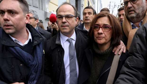 Jordi Turull, a Catalan separatist leader, walks with his wife Blanca Bragulat after leaving Spain's Supreme Court in Madrid where he testified for an investigation into his role in Catalonia's bid for independence, March 23, 2018