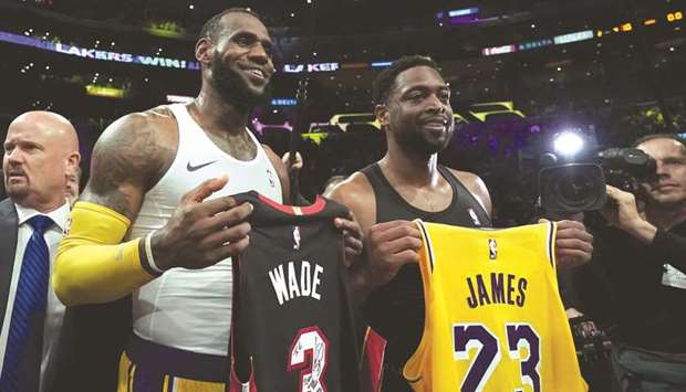 LeBron James (left) of the Los Angeles Lakers and Dwyane Wade of the Miami Heat pose after exchanging their jerseys after a 108-105 Laker win at Staples Center in Los Angeles. (Getty Images/AFP)