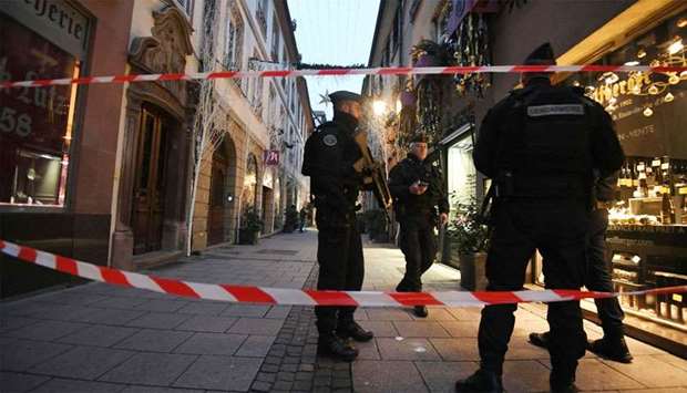 Police officers patrol the streets searching for the gunman who opened fire near a Christmas market  in Strasbourg