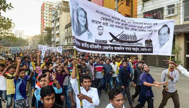 Supporters of Bangladesh Awami League march in the street as they take part in a general election campaign procession in Dhaka