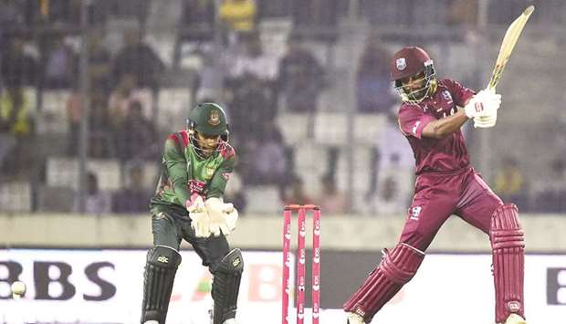 West Indiesu2019 Shai Hope (right) plays a shot as Bangladeshu2019s Mushfiqur Rahim looks on during the second ODI in Dhaka yesterday. (AFP)