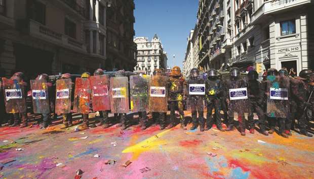 In this file photo taken on September 29, Catalan regional police u2018Mossos Du2019Esquadrau2019 officers, covered in paint, stand guard after clashing with separatist protesters during a counter-protest in Barcelona against a demonstration in support of Spanish police.