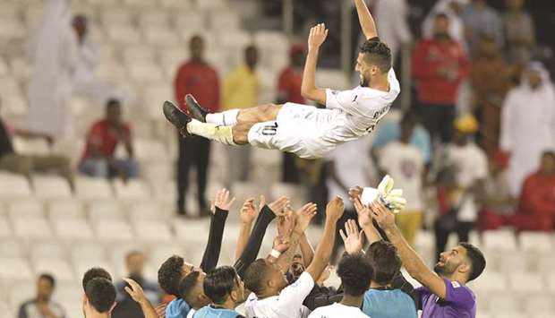 Itu2019s all up in the air:  Al Saddu2019s Hassan al-Haydos gets some special treatment from his teammates after the teamu2019s win over Al Duhail. At bottom, fans take a selfie with Baghdad Bounedjah. PICTURES: Noushad Thekkayil