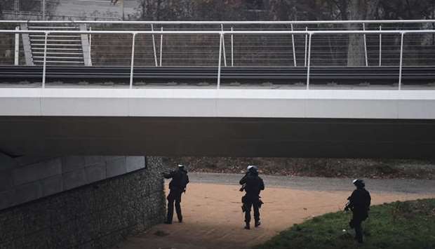 Members of the French police special forces RAID conduct searches on a bank of the river Rhine in Strasbourg in order to find the gunman who opened fire near a Christmas market the night before, in Strasbourg, eastern France