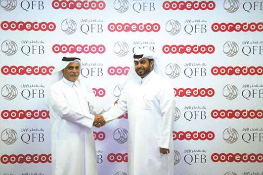 Yousuf Abdulla al-Kubaisi and Mohamed al-Sahli shake hands after signing the partnership.