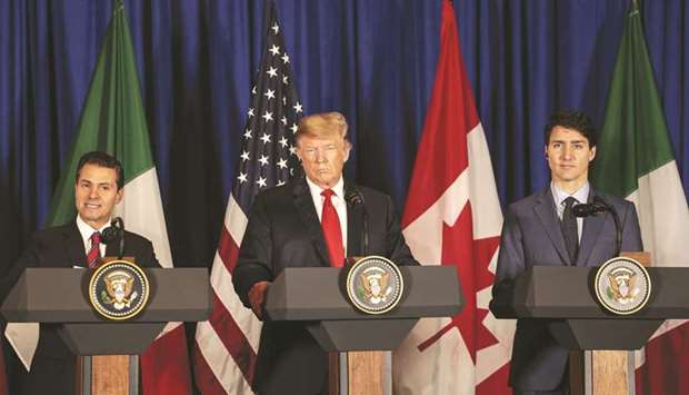 Enrique Pena Nieto, Mexicou2019s president (left), speaks, as US president Donald Trump (centre) and Justin Trudeau, Canadau2019s prime minister, listen before the signing of the United States-Mexico-Canada Agreement (USMCA) at the G20 Leadersu2019 Summit in Buenos Aires yesterday. The three leaders agreed on a deal in principle to govern more than a trillion dollars of mutual trade after a year and a half of acrimonious negotiations.
