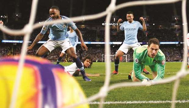 Manchester Cityu2019s Raheem Sterling (left) scores a goal against Bournemouth during their match in Manchester yesterday. (Reuters)