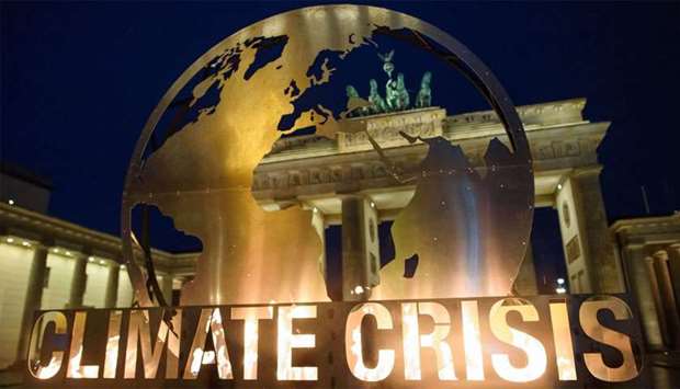 Berlin's landmark the Brandenburg Gate is seen through a giant globe installation erected by Greenpeace environmentalists