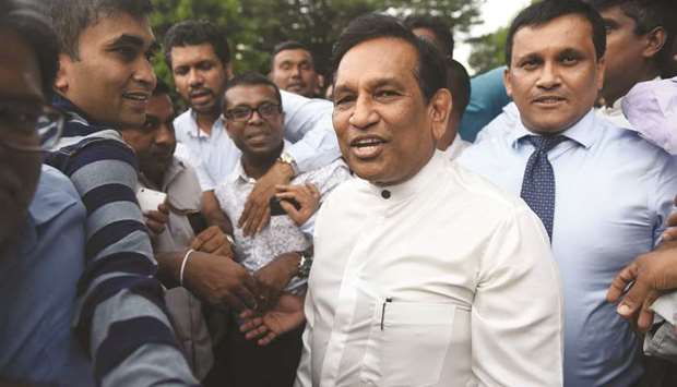 Sri Lankan member of parliament Rajeetha Senarathna (centre), and loyalist to ousted prime minister Ranil Wickremesinghe, outside the Sri Lankan Supreme Court in Colombo.