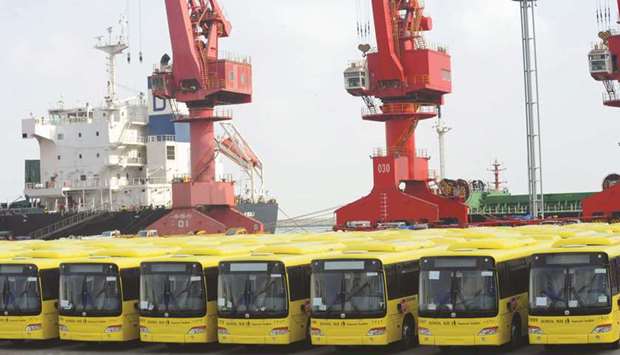 Buses wait to be exported in Lianyungang port. Chinau2019s economic growth slowed to 6.5% in the third quarter, the weakest since the global financial crisis, although the full-year expansion could slightly exceed the governmentu2019s target of around 6.5%.