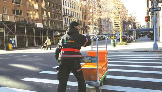 A worker pushes a cart of grocery crates during a FreshDirect delivery in New York. The shortfall in blue-collar workers is being driven by a shrinking supply of manual and low-pay service workers as the labour force becomes more educated and less willing to take on such jobs, according to a new Conference Board study.