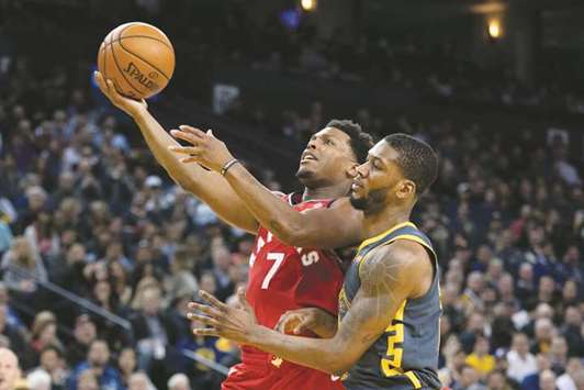 Toronto Raptors guard Kyle Lowry (left) shoots the basketball against Golden State Warriors forward Alfonzo McKinnie during the fourth quarter at Oracle Arena. PICTURE: USA TODAY Sports