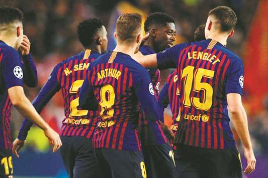 Barcelonau2019s Ousmane Dembele (second from right) is congratulated by teammates after his goal against Tottenham during the UEFA Champions League group B match in Barcelona on Tuesday. (AFP)