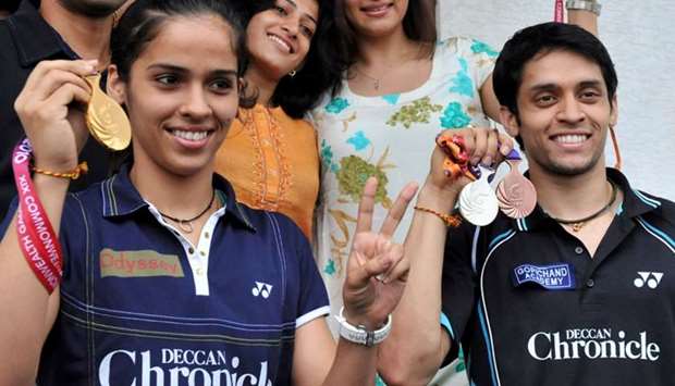 In this file photo taken on October 16, 2010, Indian badminton players Saina Nehwal (L) and Parupalli Kashyap pose with their New Delhi Commonwealth Games medals prior to a press conference in Hyderabad