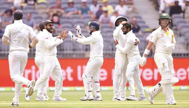 Indiau2019s Hanuma Vihari (second from right) celebrates with teammates after dismissing Australiau2019s Marcus Harris (right) on the first day of the second Test in Perth yesterday. (AFP)