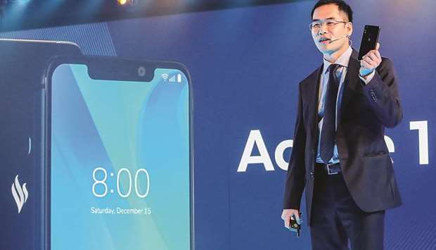 Vingroupu2019s mobile phone subsidiary VinSmartu2019s chief executive officer Tran Minh Trung presents the u201cActive 1+u201d smartphone during a launch in Ho Chi Minh city yesterday. Vietnamu2019s largest private conglomerate unveiled its first made-in-Vietnam mobile phones in the fast-growing country where it will face tough competition from tech giants like Samsung, Oppo and Apple.