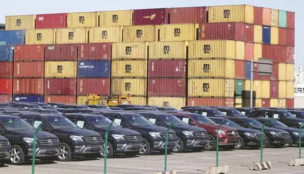 Imported Mercedes-Benz cars are seen next to containers at Tianjin Port, in northern China. Beijing pressed on with its trade war truce with the US yesterday, announcing it will suspend extra tariffs added to US-made cars and auto parts for three months from January 1.