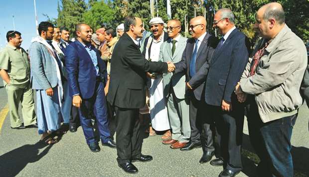 Members of the Houthi delegation (left) returning from peace talks in Sweden shake hands with supporters upon their arrival at Sanaa International Airport in the Yemeni capital, yesterday.
