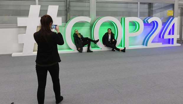 Participants pose for a picture during the final session of the COP24 summit on climate change in Katowice, Poland