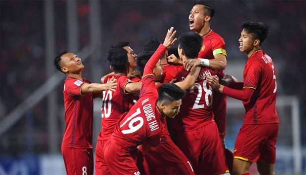 Vietnam's players celebrate scoring a goal during the AFF Suzuki Cup 2018 final football match between Vietnam and Malaysia
