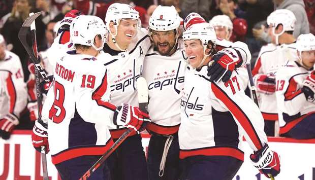 Washington Capitals' Alex Ovechkin (second right) celebrates with teammates after scoring against Carolina Hurricanes.
