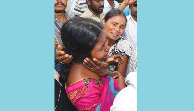 Relatives grieve after at least 13 people died of food poisoning, in Chamarajanagar district yesterday.