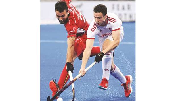 Belgiumu2019s Simon Gougnard (left) fights for the ball with Englandu2019s Phil Roper during the 2018 Hockey World Cup semi-final in Bhubaneswar, India, yesterday. (AFP)